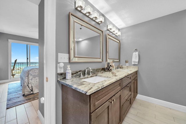 122 Seascape Dr Unit 1104, Miramar Beach, FL 32550 - full bath featuring double vanity, baseboards, and wood finished floors