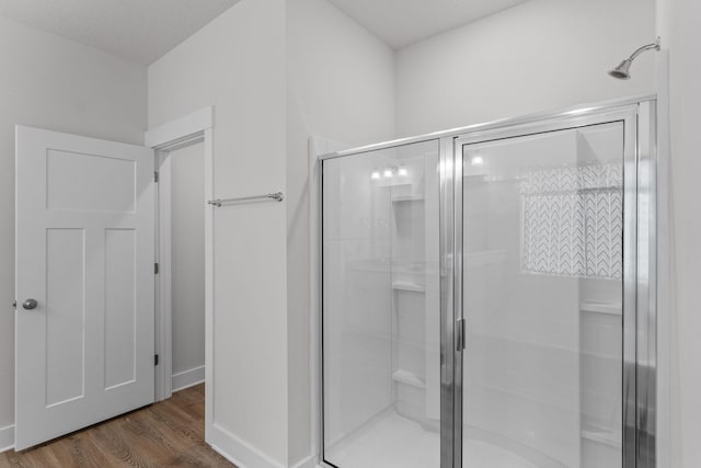 608 Champ Trl, Crestview, FL 32539 - full bathroom featuring a stall shower and wood finished floors