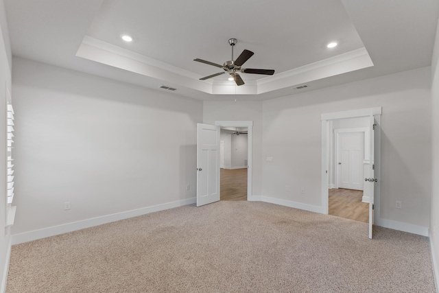 608 Champ Trl, Crestview, FL 32539 - unfurnished bedroom featuring a tray ceiling, light colored carpet, recessed lighting, baseboards, and ceiling fan