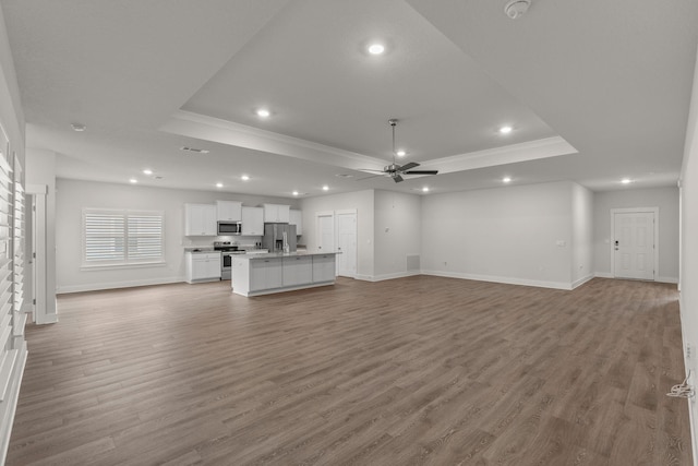 608 Champ Trl, Crestview, FL 32539 - unfurnished living room with a raised ceiling, crown molding, recessed lighting, ceiling fan, and baseboards