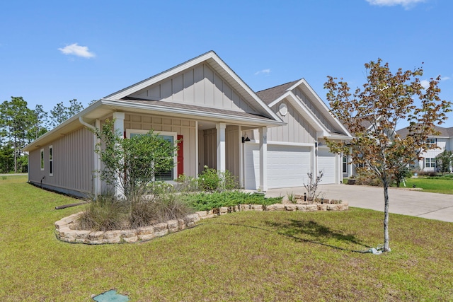 608 Champ Trl, Crestview, FL 32539 - view of front of property featuring board and batten siding, concrete driveway, a garage, and a front yard