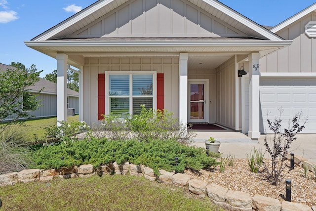 608 Champ Trl, Crestview, FL 32539 - view of front of house featuring board and batten siding, covered porch, and an attached garage