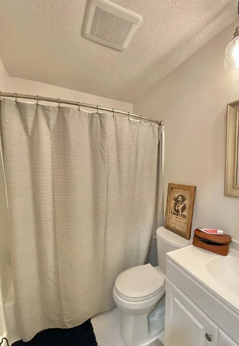 123 NW Sotir St, Fort Walton Beach, FL 32548 - full bath with a textured ceiling, toilet, and vanity