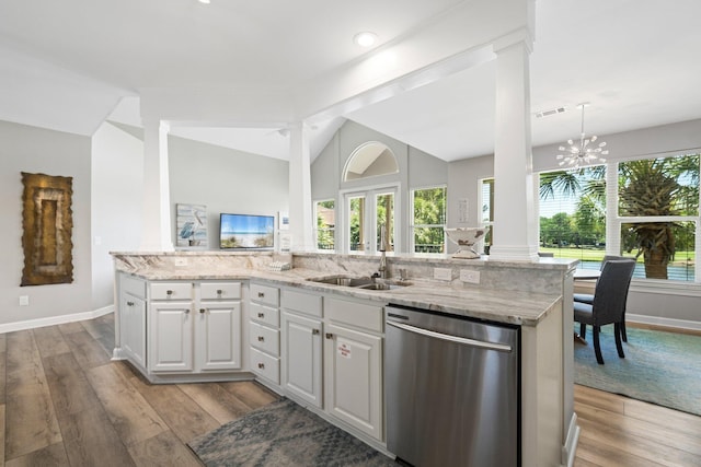 8512 Turnberry Ct Unit 8512, Miramar Beach, FL 32550 - kitchen featuring dishwasher, a sink, light stone counters, baseboards, and vaulted ceiling