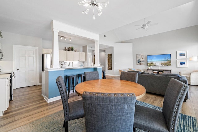 8512 Turnberry Ct Unit 8512, Miramar Beach, FL 32550 - dining area featuring light wood-style flooring, decorative columns, a ceiling fan, lofted ceiling, and baseboards
