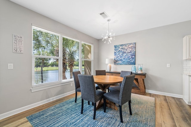 8512 Turnberry Ct Unit 8512, Miramar Beach, FL 32550 - dining space featuring a chandelier, baseboards, and light wood-type flooring