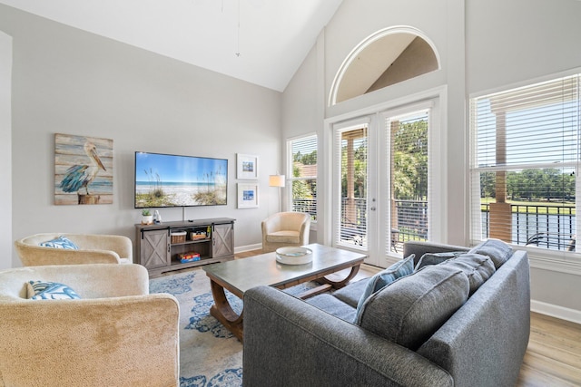 8512 Turnberry Ct Unit 8512, Miramar Beach, FL 32550 - living room featuring french doors, wood finished floors, healthy amount of natural light, baseboards, and high vaulted ceiling