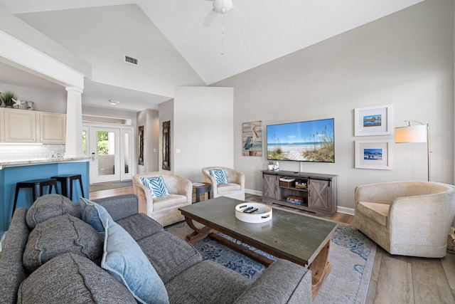 8512 Turnberry Ct Unit 8512, Miramar Beach, FL 32550 - living room with wood finished floors, ceiling fan, high vaulted ceiling, decorative columns, and baseboards