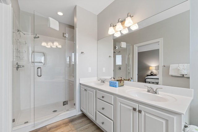 8512 Turnberry Ct Unit 8512, Miramar Beach, FL 32550 - bathroom featuring ensuite bath, double vanity, a stall shower, and wood finished floors
