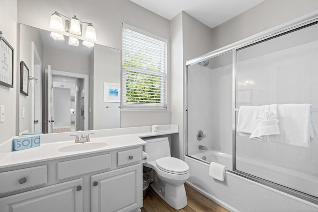 8512 Turnberry Ct Unit 8512, Miramar Beach, FL 32550 - bathroom with toilet, wood finished floors, vanity, and combined bath / shower with glass door