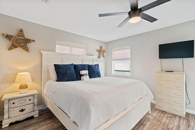 4508 Luke Ave, Destin, FL 32541 - bedroom featuring wood finished floors, ceiling fan, a textured ceiling, and baseboards