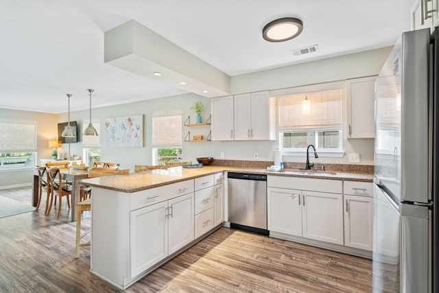 4508 Luke Ave, Destin, FL 32541 - kitchen with a sink, stainless steel appliances, a peninsula, white cabinets, and recessed lighting