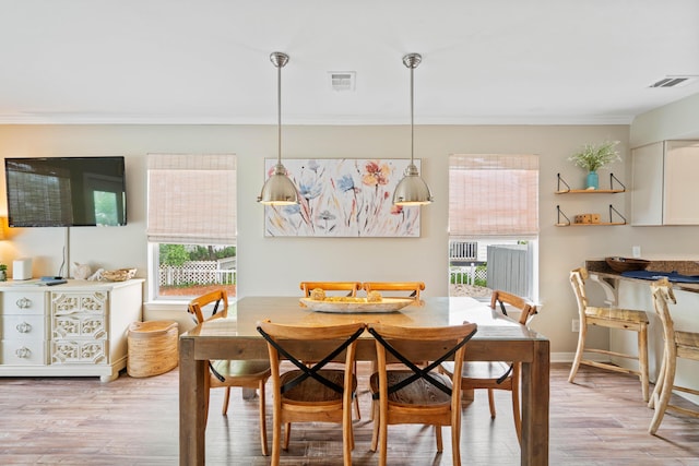 4508 Luke Ave, Destin, FL 32541 - dining area featuring plenty of natural light, crown molding, light wood-style flooring, and baseboards