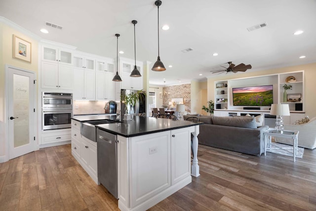 1725 Vinson Ray Rd, Baker, FL 32531 - kitchen with a sink, appliances with stainless steel finishes, dark countertops, wood finished floors, and recessed lighting