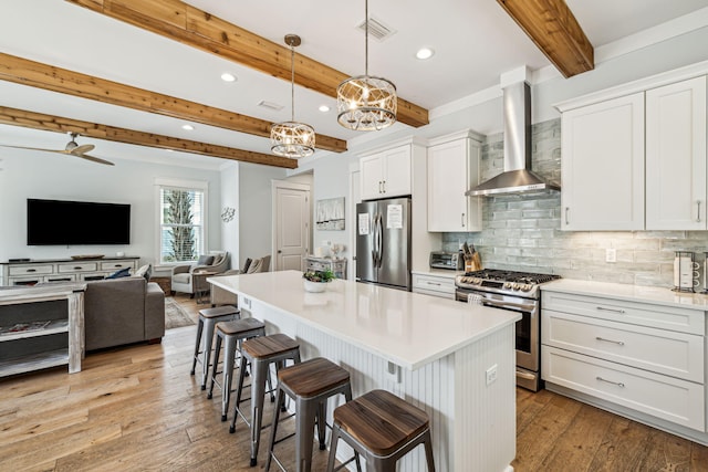 60 Barefoot Ln, Inlet Beach, FL 32461 - kitchen with appliances with stainless steel finishes, wall chimney exhaust hood, beamed ceiling, tasteful backsplash, and a kitchen breakfast bar