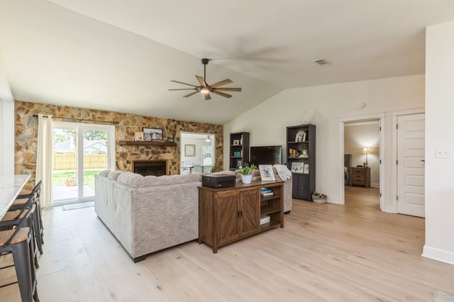 1148 Pin Oak Cir, Niceville, FL 32578 - living room featuring a ceiling fan, light wood finished floors, a fireplace, lofted ceiling, and baseboards