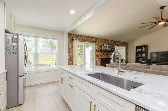 1148 Pin Oak Cir, Niceville, FL 32578 - kitchen with freestanding refrigerator, a sink, open floor plan, light wood-style flooring, and a fireplace