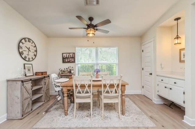 1148 Pin Oak Cir, Niceville, FL 32578 - dining area with light wood finished floors, a ceiling fan, and baseboards