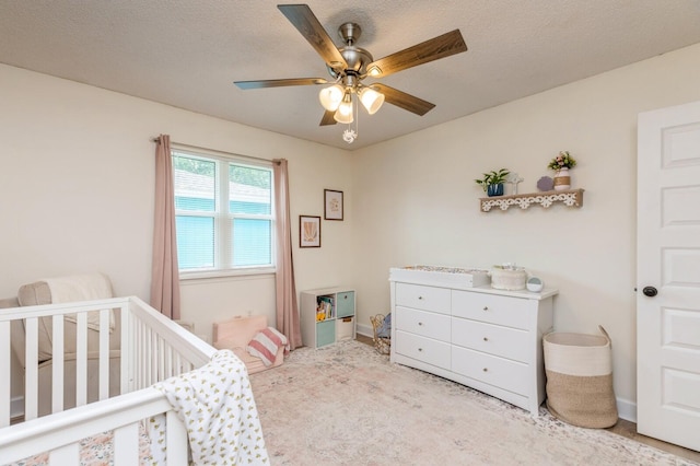 1148 Pin Oak Cir, Niceville, FL 32578 - bedroom with a nursery area, ceiling fan, carpet, and baseboards