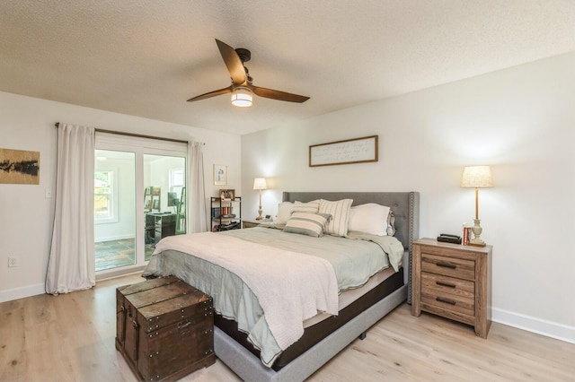 1148 Pin Oak Cir, Niceville, FL 32578 - bedroom with light wood-type flooring, baseboards, access to exterior, a textured ceiling, and a ceiling fan