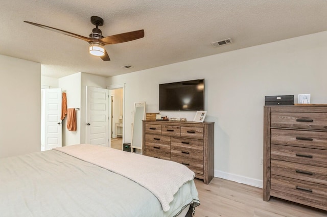 1148 Pin Oak Cir, Niceville, FL 32578 - bedroom with light wood-style flooring, baseboards, ceiling fan, and a textured ceiling