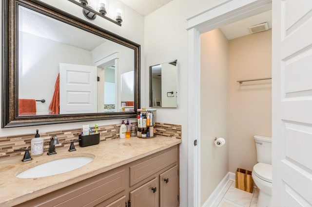 1148 Pin Oak Cir, Niceville, FL 32578 - bathroom with toilet, marble finish floors, backsplash, and vanity