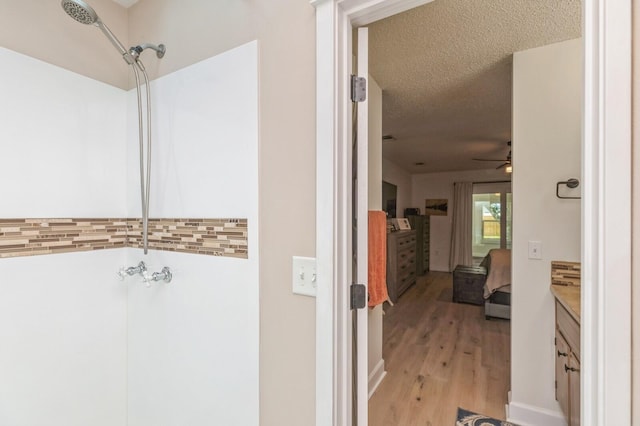 1148 Pin Oak Cir, Niceville, FL 32578 - bathroom featuring wood finished floors, a ceiling fan, vanity, and a textured ceiling