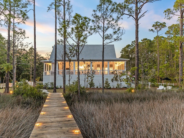 241 N 7th St, Santa Rosa Beach, FL 32459 - back of property with a sunroom