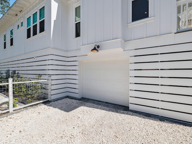 241 N 7th St, Santa Rosa Beach, FL 32459 - view of property exterior featuring board and batten siding, an attached garage, and driveway