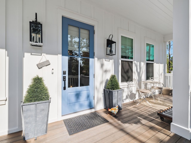 241 N 7th St, Santa Rosa Beach, FL 32459 - property entrance featuring covered porch and board and batten siding