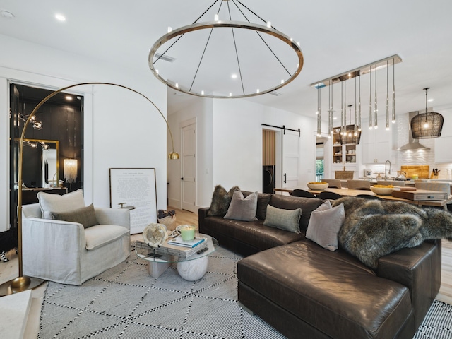 241 N 7th St, Santa Rosa Beach, FL 32459 - living room featuring a chandelier and a barn door