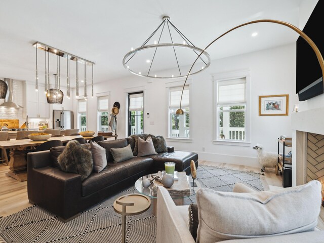 241 N 7th St, Santa Rosa Beach, FL 32459 - living area with light wood-style floors, plenty of natural light, recessed lighting, a chandelier, and baseboards