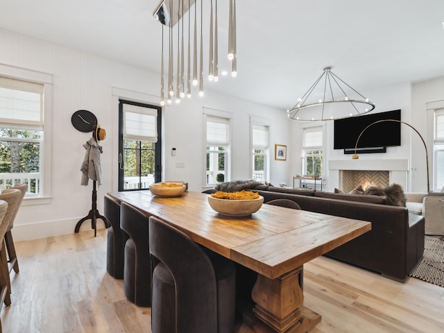 241 N 7th St, Santa Rosa Beach, FL 32459 - dining area featuring light wood-type flooring, a chandelier, and baseboards