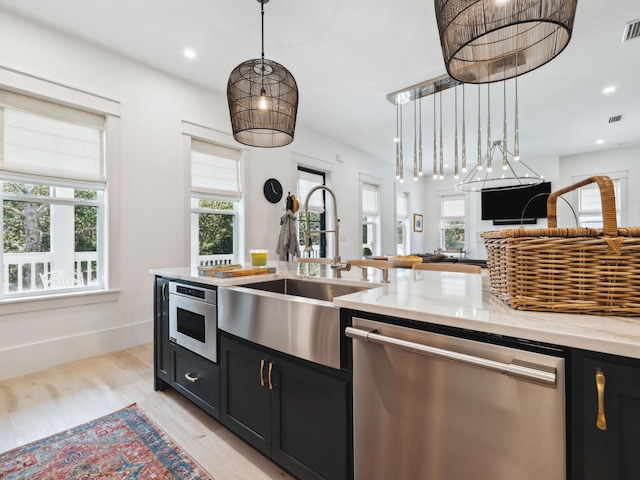 241 N 7th St, Santa Rosa Beach, FL 32459 - kitchen with stainless steel appliances, a sink, open floor plan, dark cabinets, and recessed lighting