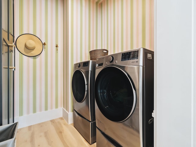 241 N 7th St, Santa Rosa Beach, FL 32459 - laundry area featuring washer and dryer, wood finished floors, and baseboards