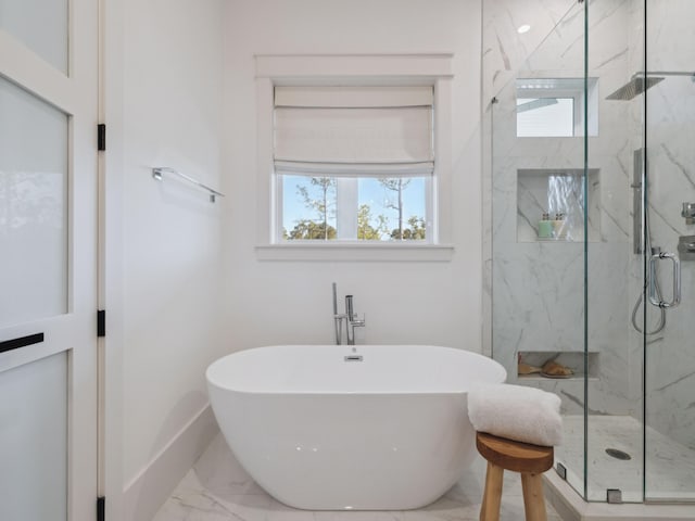 241 N 7th St, Santa Rosa Beach, FL 32459 - bathroom featuring marble look tile flooring, a marble finish shower, a soaking tub, and baseboards