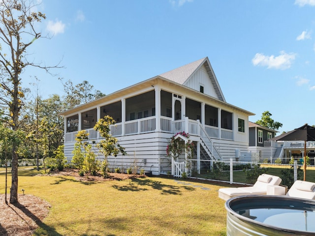 241 N 7th St, Santa Rosa Beach, FL 32459 - view of front of home with a sunroom, stairs, and a front lawn