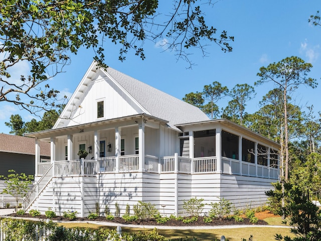 241 N 7th St, Santa Rosa Beach, FL 32459 - view of front of property with board and batten siding, a porch, stairs, a sunroom, and a shingled roof