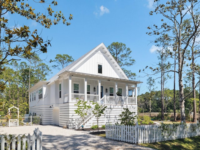 241 N 7th St, Santa Rosa Beach, FL 32459 - view of front of property with board and batten siding, covered porch, and stairs