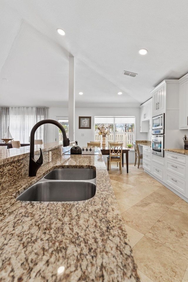 276 Sandy Cay Dr, Miramar Beach, FL 32550 - kitchen featuring a sink, stainless steel appliances, plenty of natural light, light stone counters, and recessed lighting