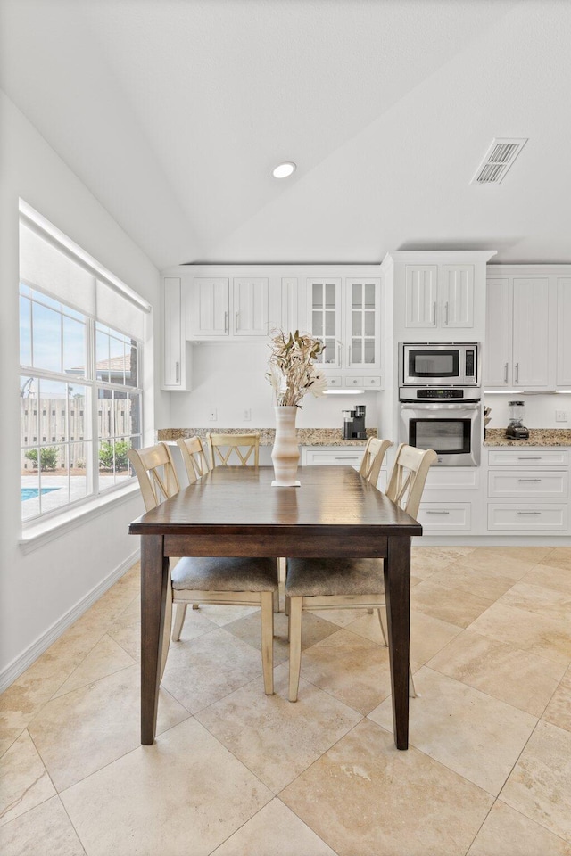 276 Sandy Cay Dr, Miramar Beach, FL 32550 - dining area with baseboards, recessed lighting, vaulted ceiling, and light tile patterned floors