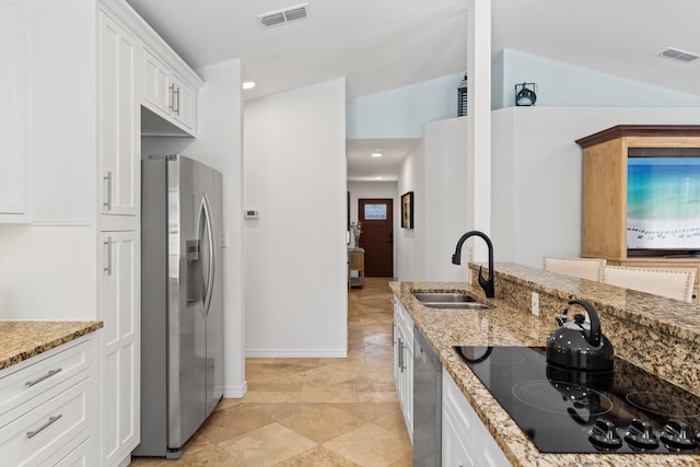 276 Sandy Cay Dr, Miramar Beach, FL 32550 - kitchen with stainless steel appliances, a sink, white cabinetry, light stone countertops, and baseboards