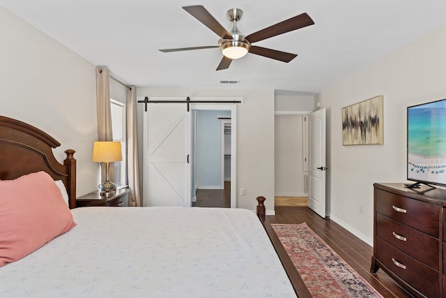 276 Sandy Cay Dr, Miramar Beach, FL 32550 - bedroom with baseboards, dark wood finished floors, a ceiling fan, and a barn door