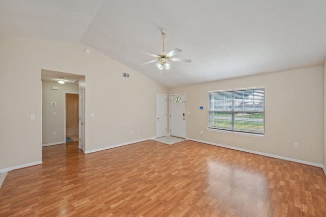 390 Brackin St, Crestview, FL 32539 - unfurnished living room featuring a ceiling fan, lofted ceiling, light wood-style floors, and baseboards