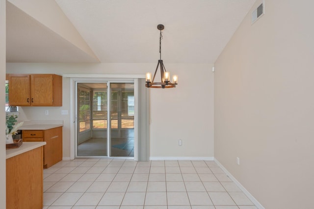 390 Brackin St, Crestview, FL 32539 - unfurnished dining area with a chandelier, lofted ceiling, baseboards, and light tile patterned floors
