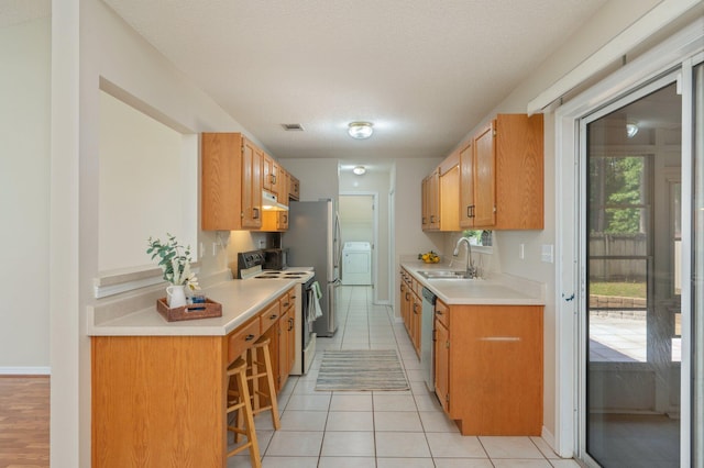 390 Brackin St, Crestview, FL 32539 - kitchen featuring electric stove, a sink, washer / dryer, dishwasher, and light countertops