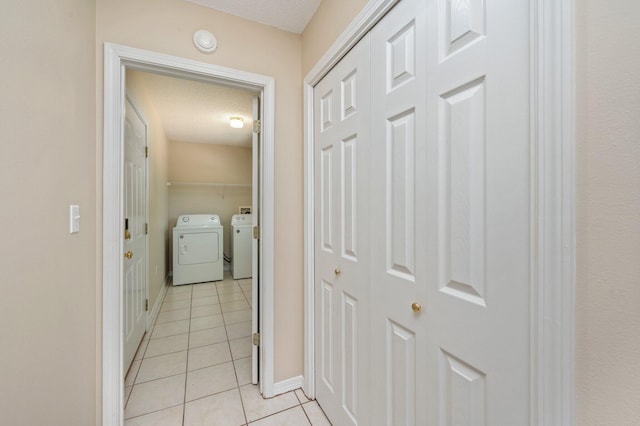 390 Brackin St, Crestview, FL 32539 - corridor featuring independent washer and dryer, light tile patterned floors, and baseboards