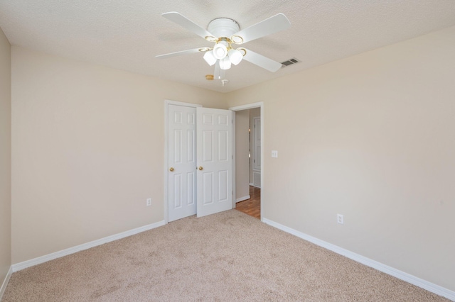 390 Brackin St, Crestview, FL 32539 - unfurnished bedroom featuring carpet flooring, baseboards, ceiling fan, and a textured ceiling