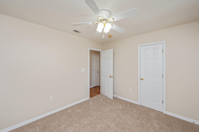 390 Brackin St, Crestview, FL 32539 - unfurnished bedroom featuring carpet, baseboards, ceiling fan, and a textured ceiling