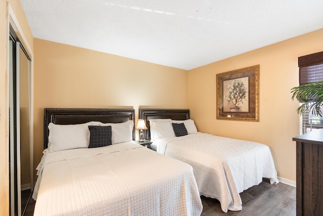 11483 Front Beach Rd Unit 202, Panama City Beach, FL 32407 - bedroom with wood finished floors, baseboards, and a closet